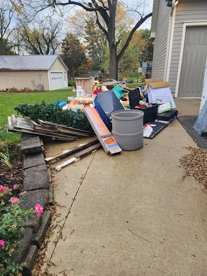 Dumpster being loaded with debris for Roofing Dumpster Rental in Conway